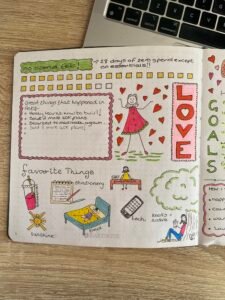 bullet journal showing a monthly layout for February with doodles, the word love and a no spend February challenge